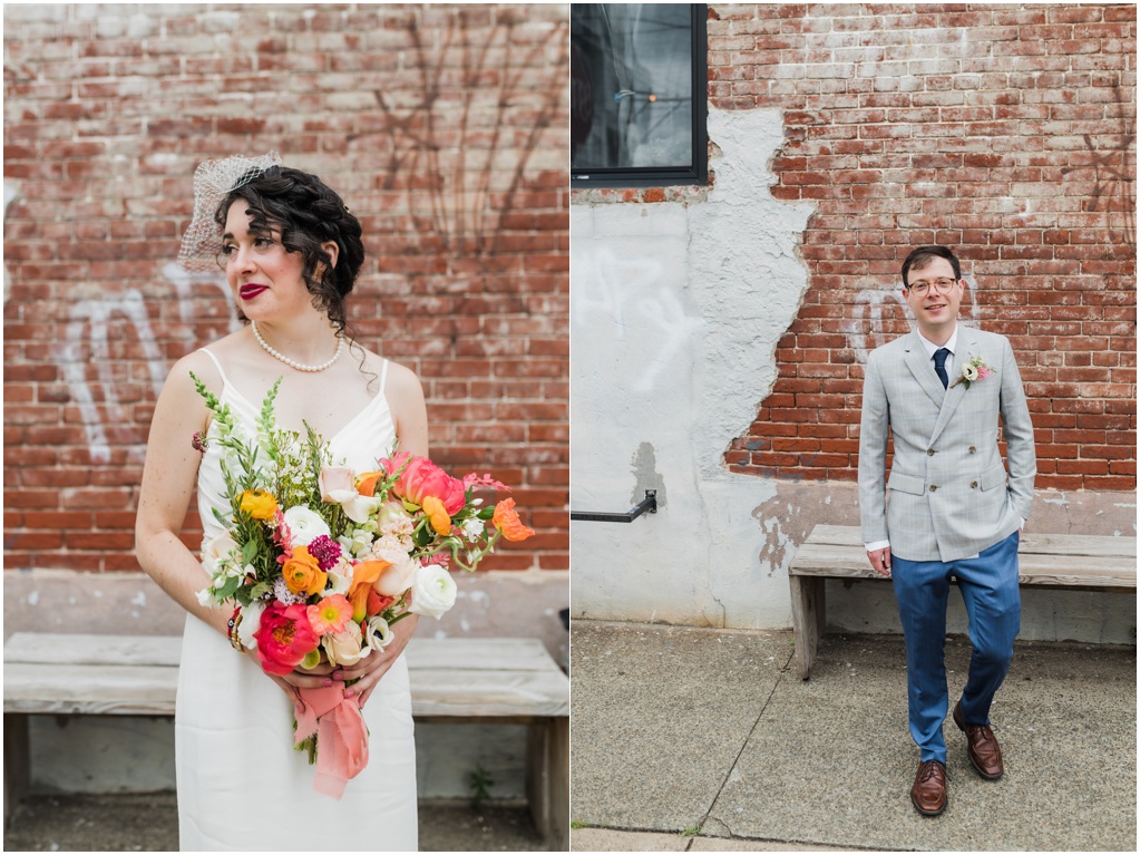 The bride and groom pose in front of a brick wall