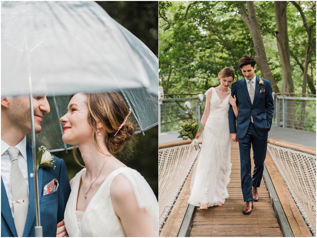 The couple walks through the rain and smiles at each other.