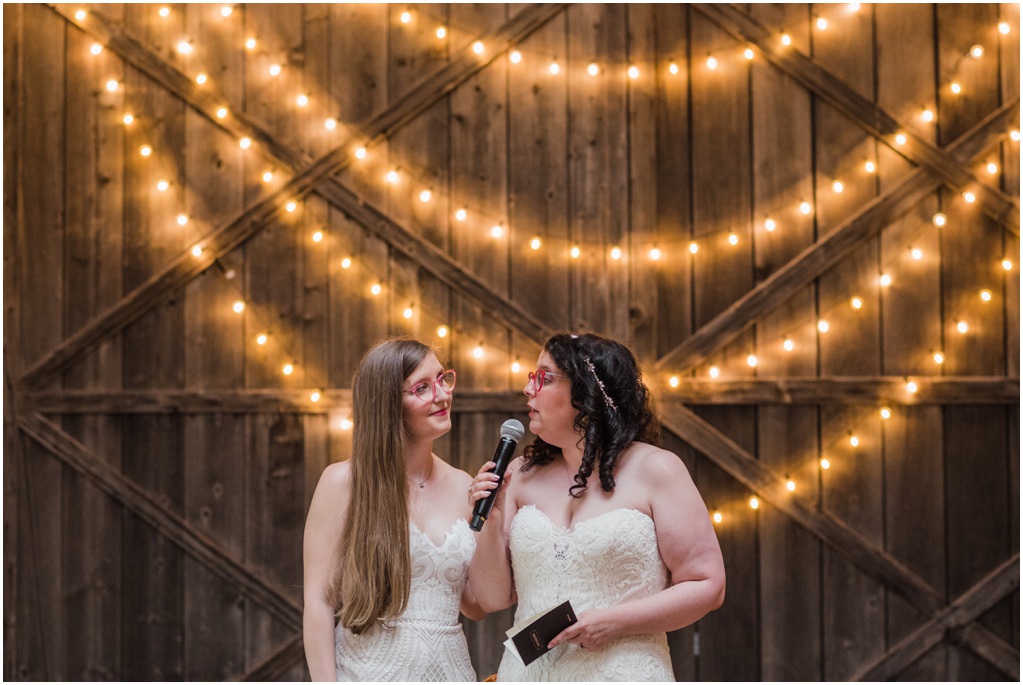 The couple makes a speech in front of strings of lights