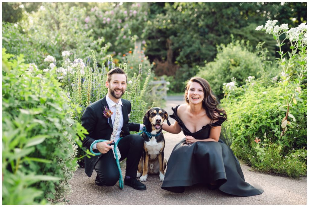 A couple poses with their dog at a Bartram's Garden wedding