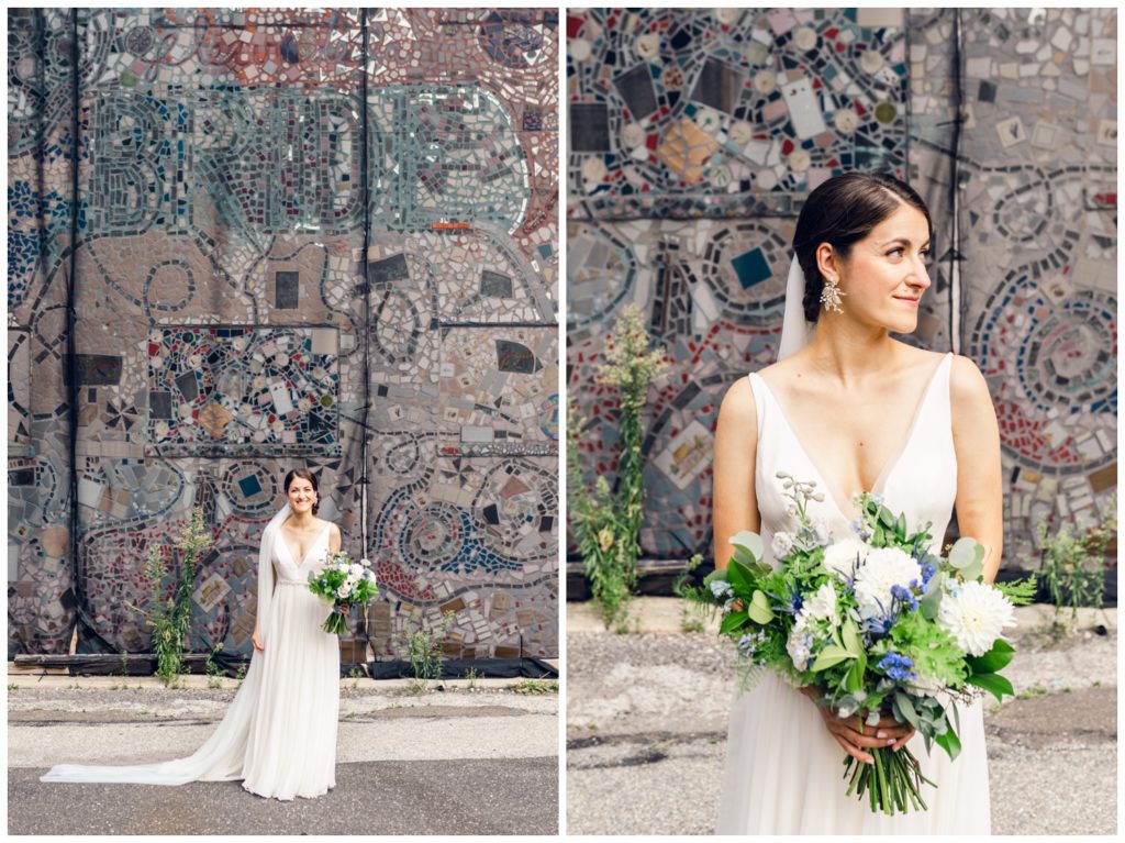The bride holds her bouquet in front of a mosaic near the Power Plant Productions wedding