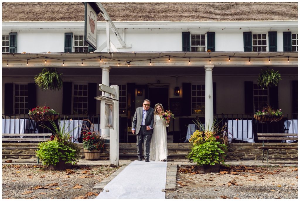 The couple walks down the steps of the Valley Green Inn wedding