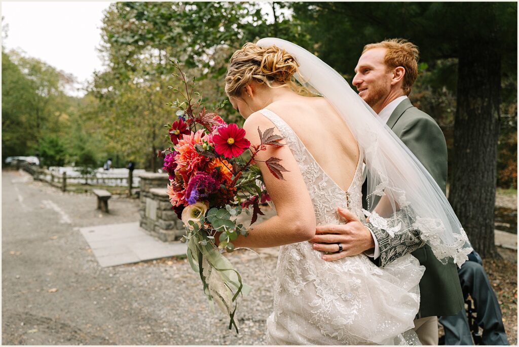 A groom puts his arm around a bride at a Valley Green Inn wedding.