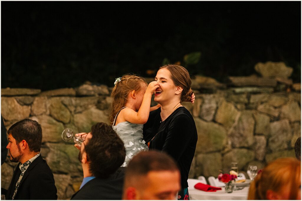 A bride holds a child.
