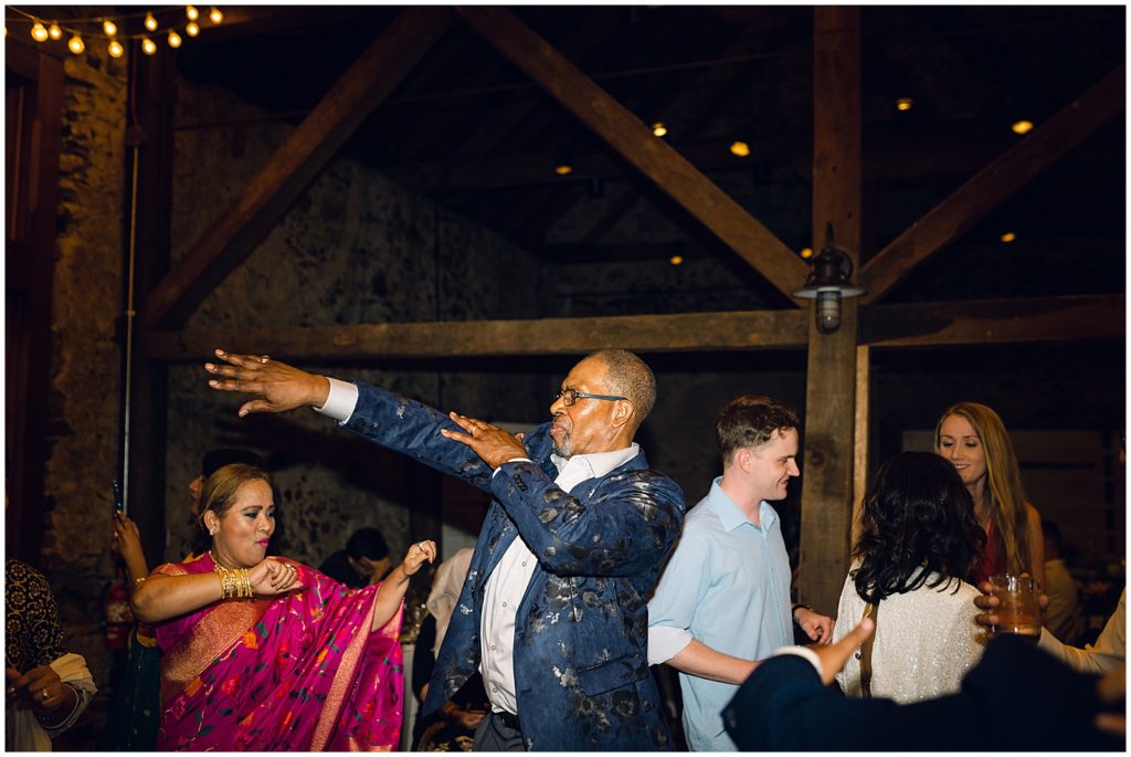 A man in a blue suit moves across the dance floor.