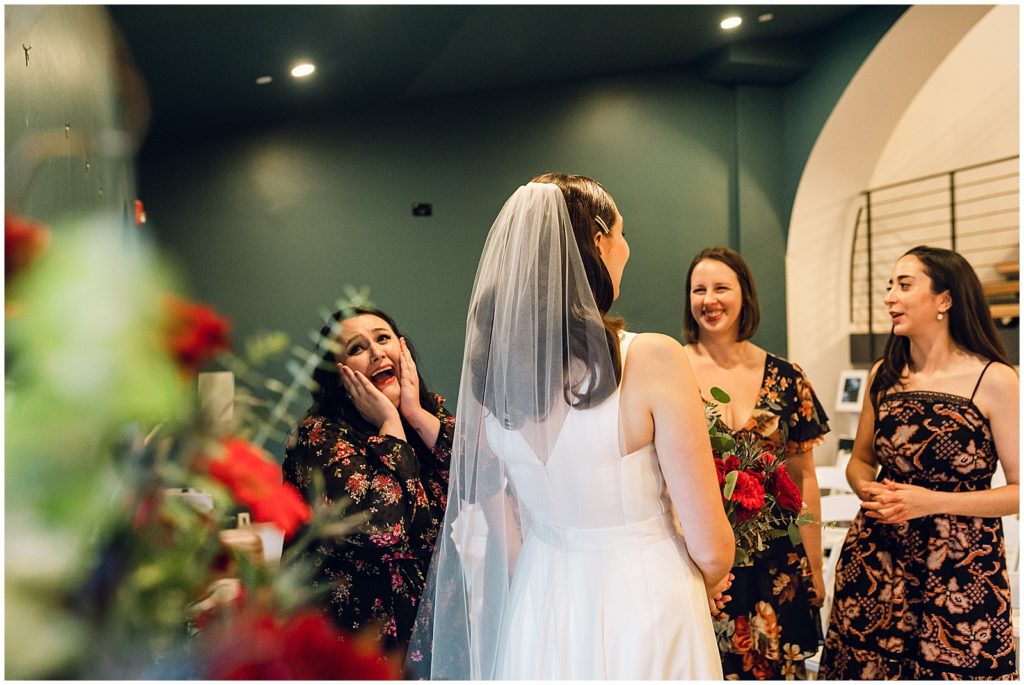 A bride talks to friends during The Deacon Philadelphia wedding.