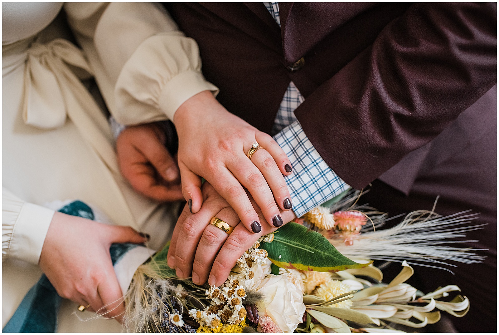 A couple holds hands at their sustainable wedding.