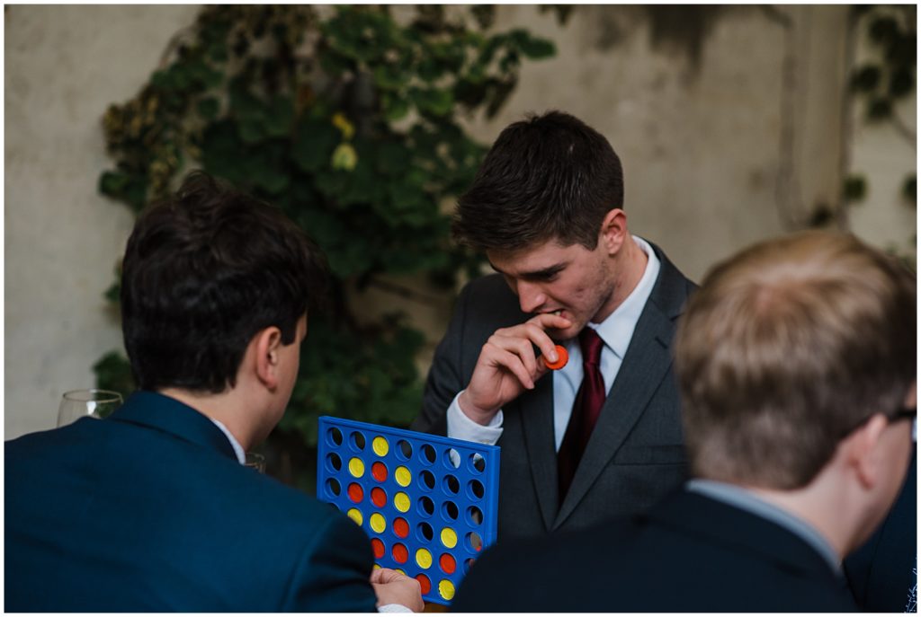 Guests play a board game at a sustainable wedding.