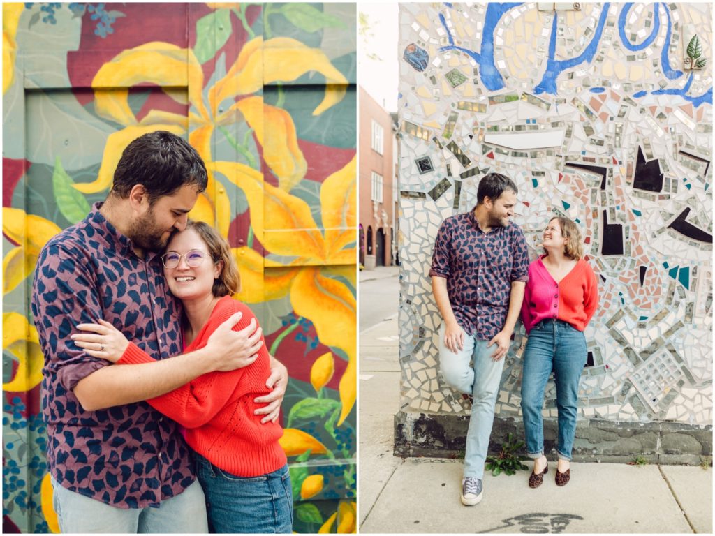 A couple poses in front of murals after their Philadelphia proposal. 