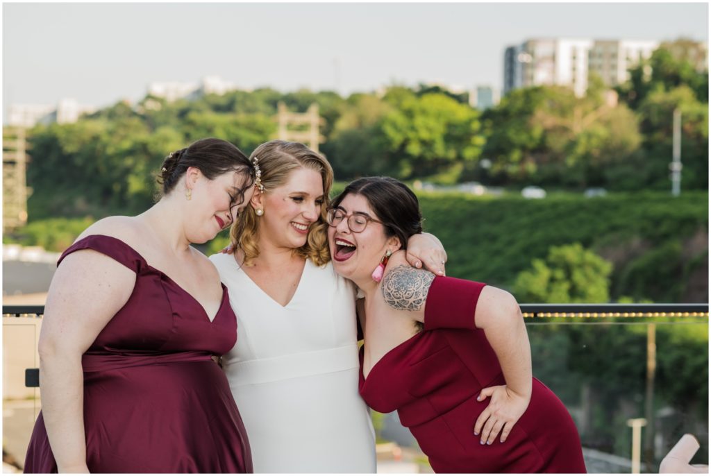 Tori hugs her bridesmaids at the rooftop wedding venue.
