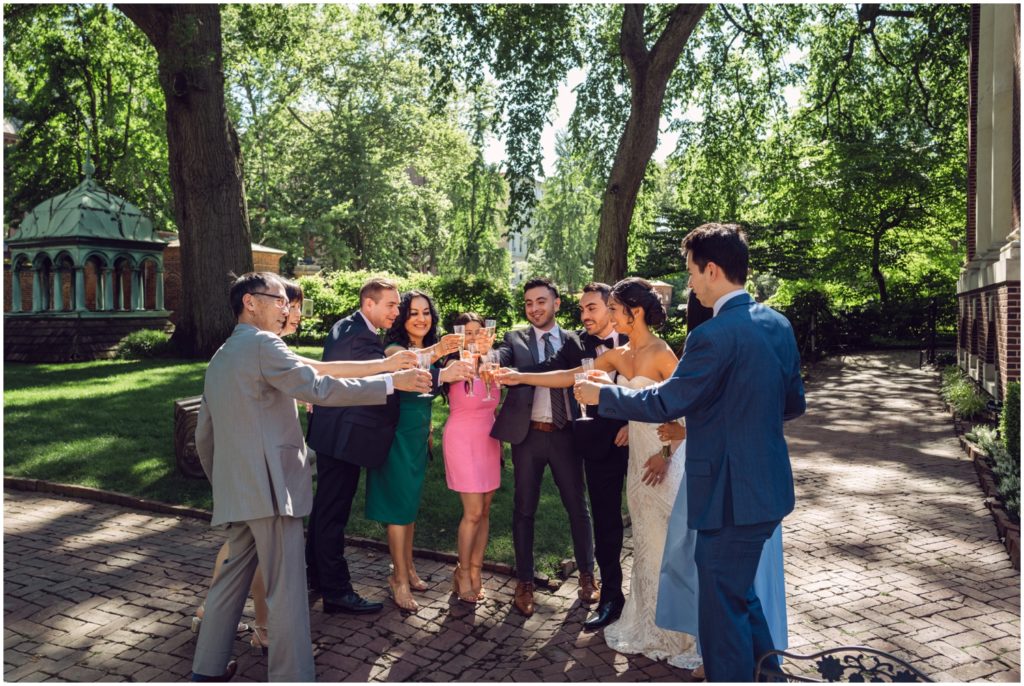 Wedding guests raise their drinks for a toast at the alternative to a wedding.
