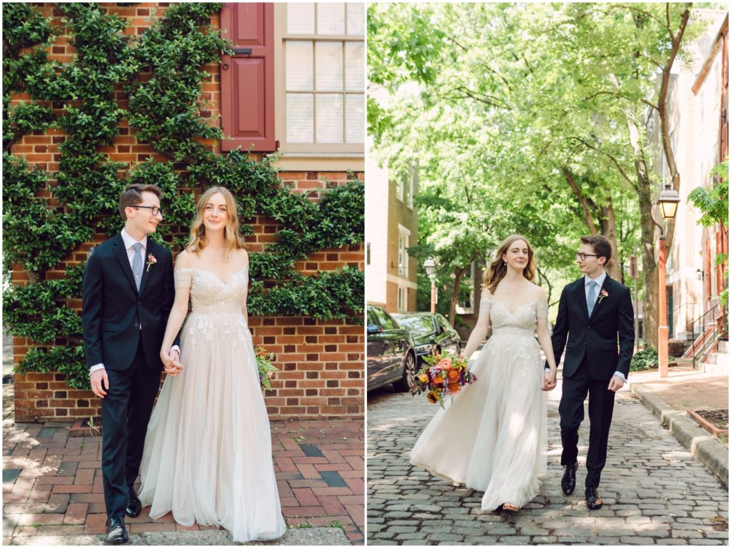 A bride and groom walk through a cobblestone courtyard at their Philadelphia wedding.