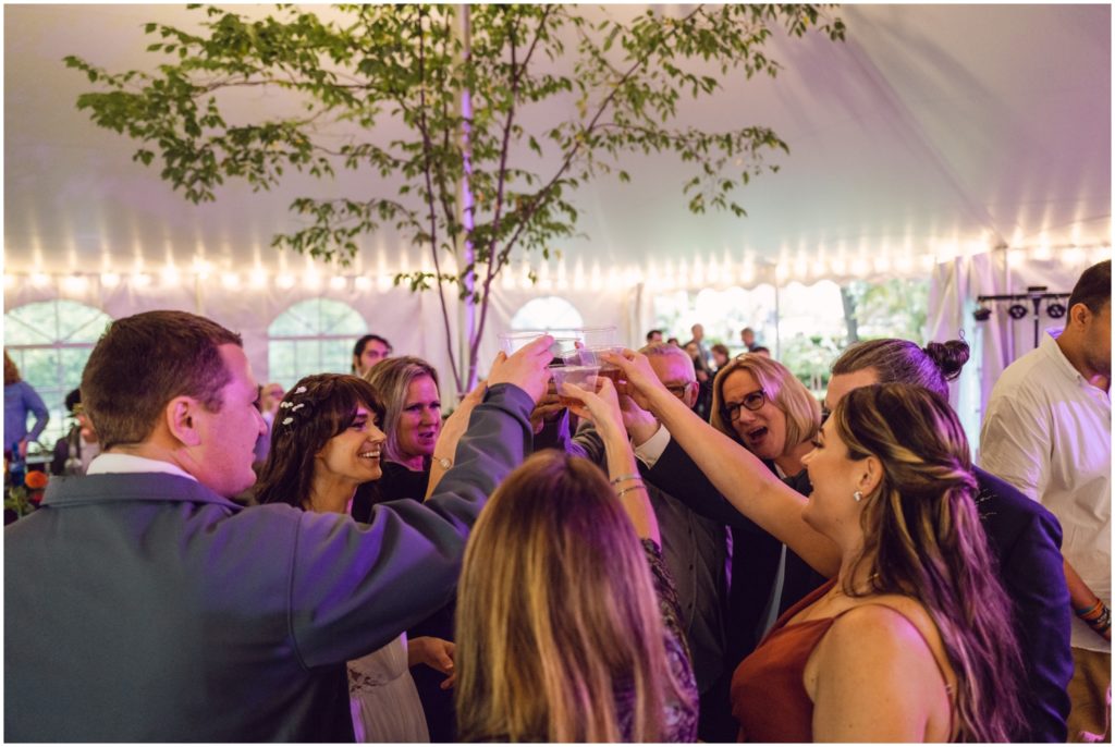 Wedding guests raise their glasses for a toast.