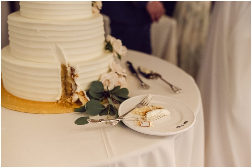 A slice of wedding cake lays on a plate.