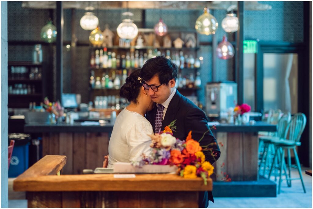 A bride and groom embrace during their self-uniting ceremony in a Philadelphia restaurant.