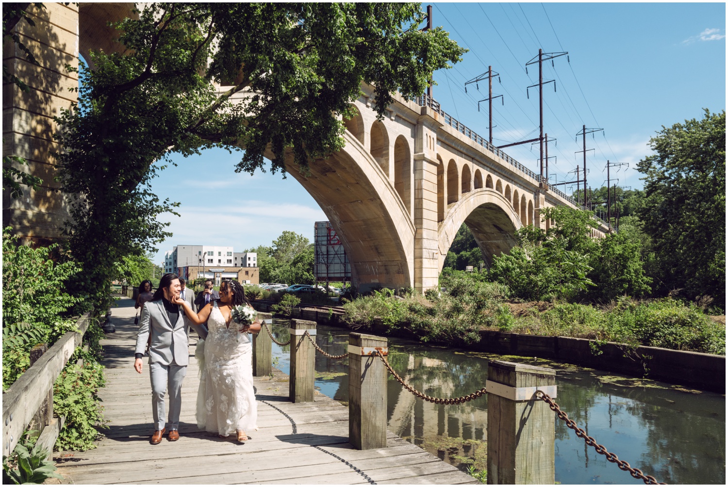 A bride and groom walk through an East Falls park after their Philadelphia elopement.