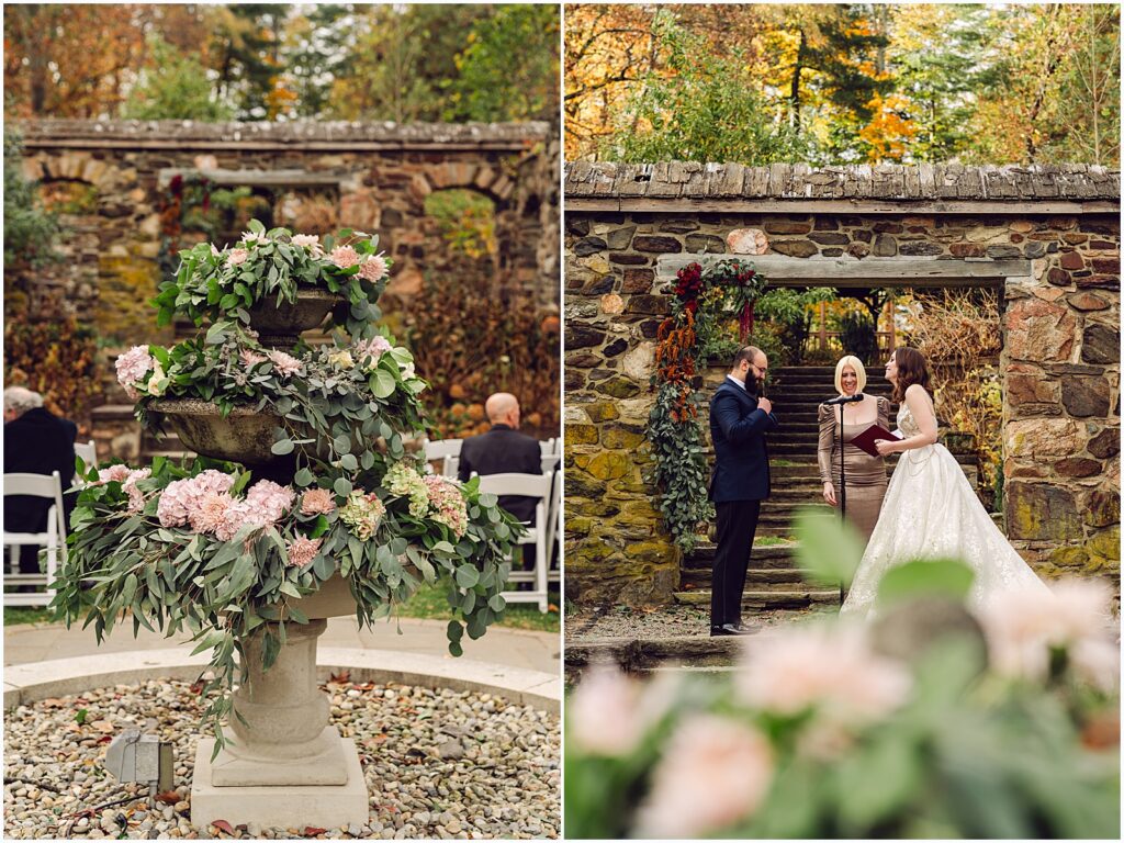 Over a centerpiece of pink flowers, a wedding ceremony takes place under a stone arch.