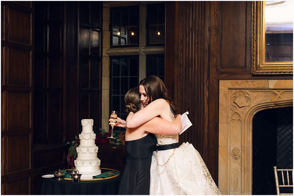 A bride hugs her maid of honor after a toast.