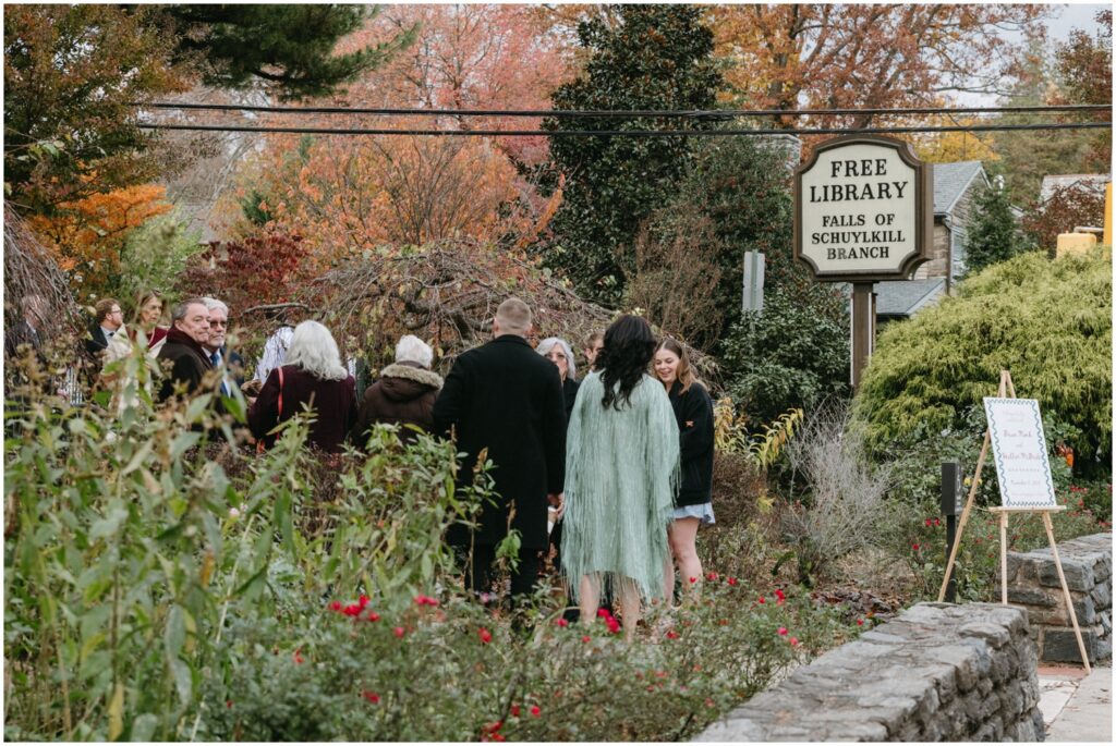 Wedding guests gather in a Philadelphia garden for a small wedding.