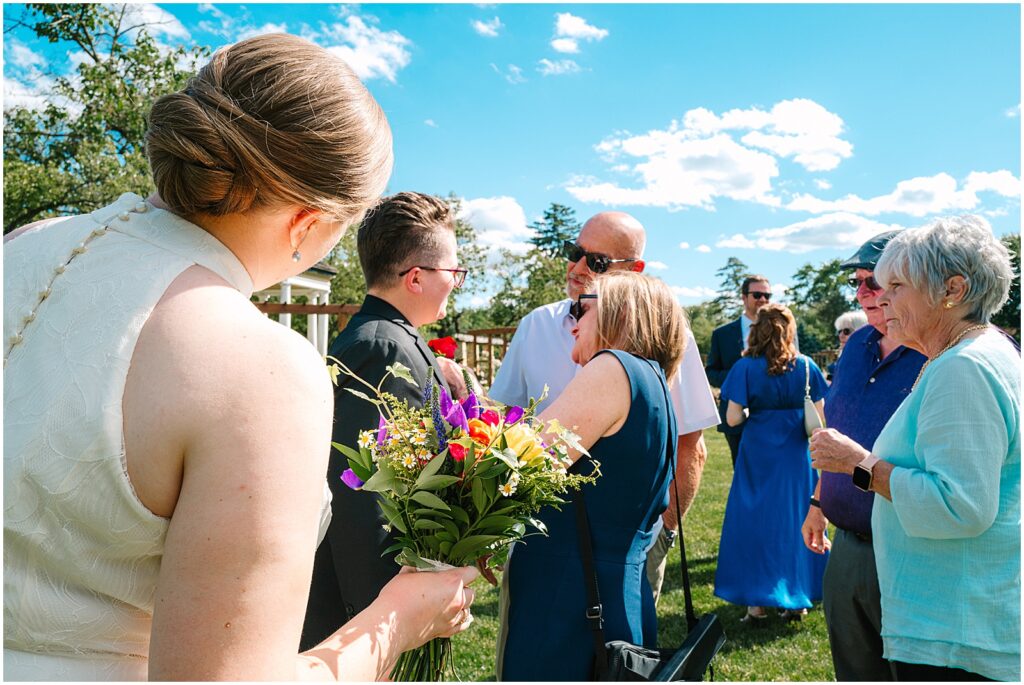 Wedding guests greet two brides at the Malcolm Gross Rose Garden.