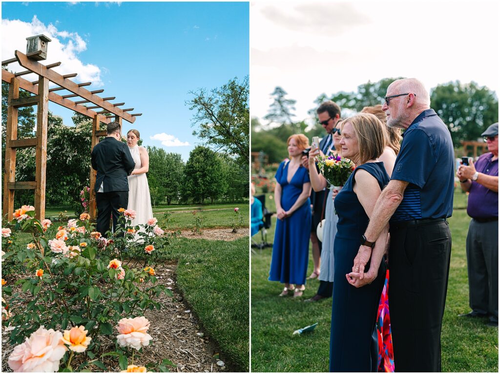 Yellow roses bloom beside a trellis where two women are getting married.