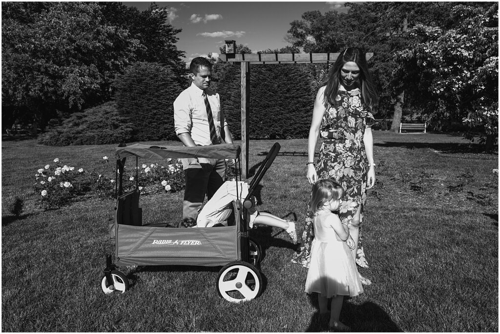 A child climbs into a wagon in a park.