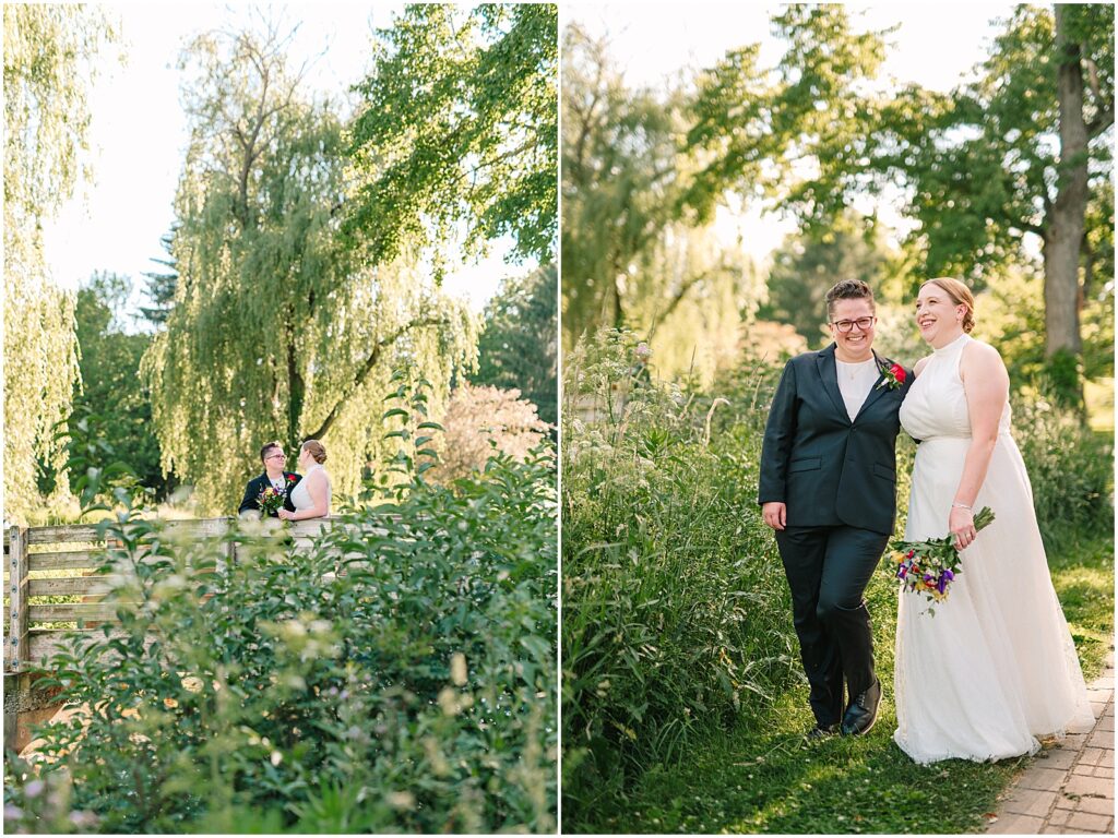 Two brides hold hands and walk through Malcolm Gross Rose Garden.