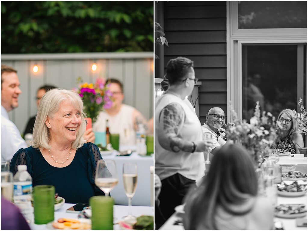 Wedding guests laugh at a toast.