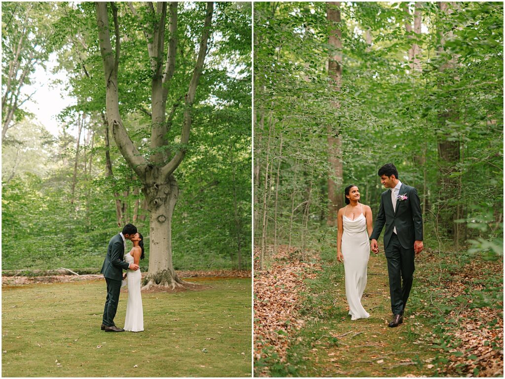 A bride and groom kiss at the edge of the woods.