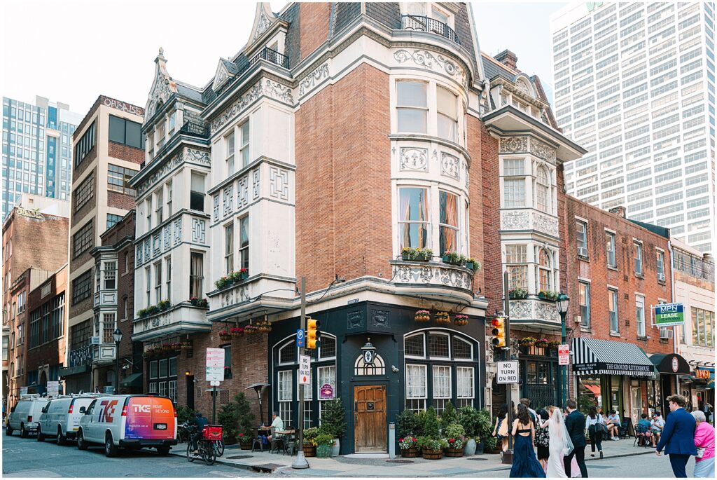 A bride and groom lead guests to a restaurant in Center City Philadelphia.