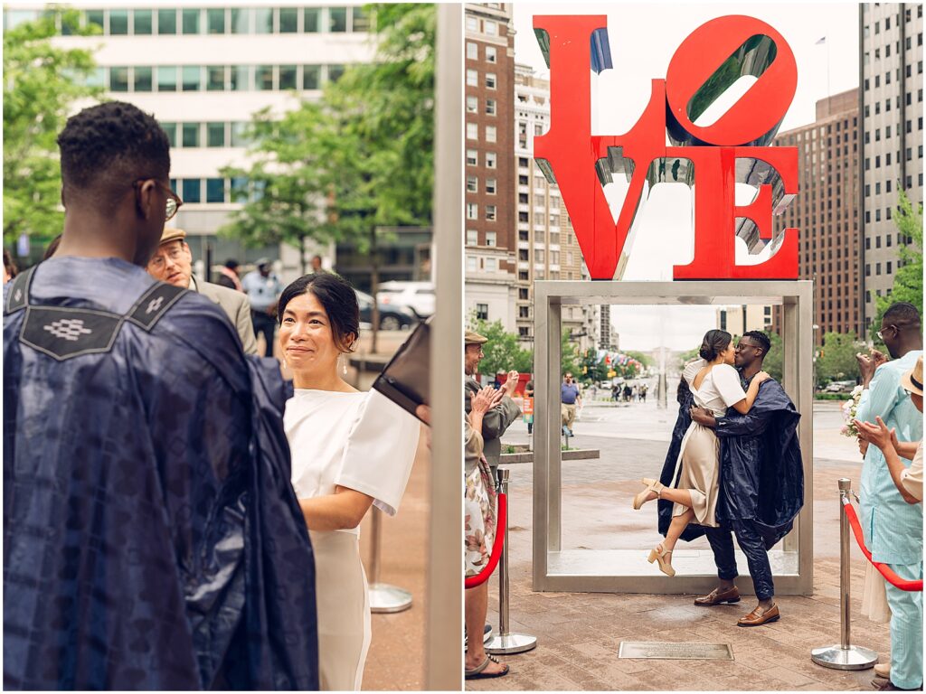 A groom lifts a bride for a kiss at their Love Park Philly wedding.