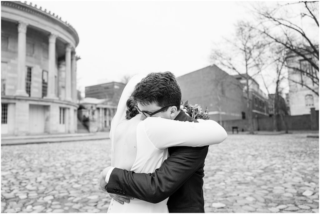 A Philadelphia bride and groom hug in a black and white wedding photo.