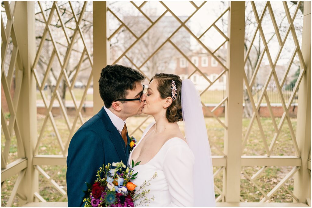 A bride and groom kiss inside a gazebo in Old City Philadelphia.