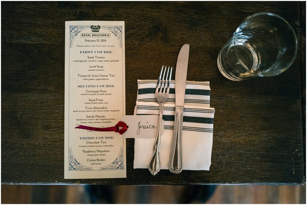 A menu for a Royal Boucherie wedding brunch sits on a table.