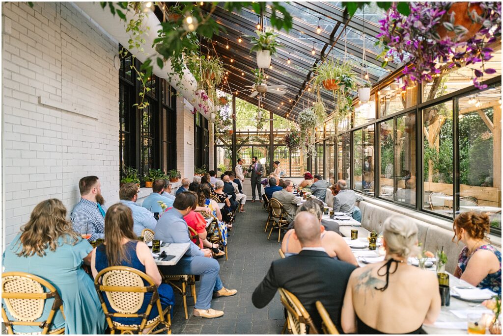 A bride and groom exchange vows on the patio of a restaurant wedding venue in Philadelphia.