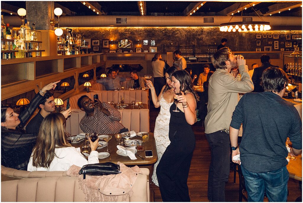 Wedding guests stand around a table at Giuseppe & Sons.