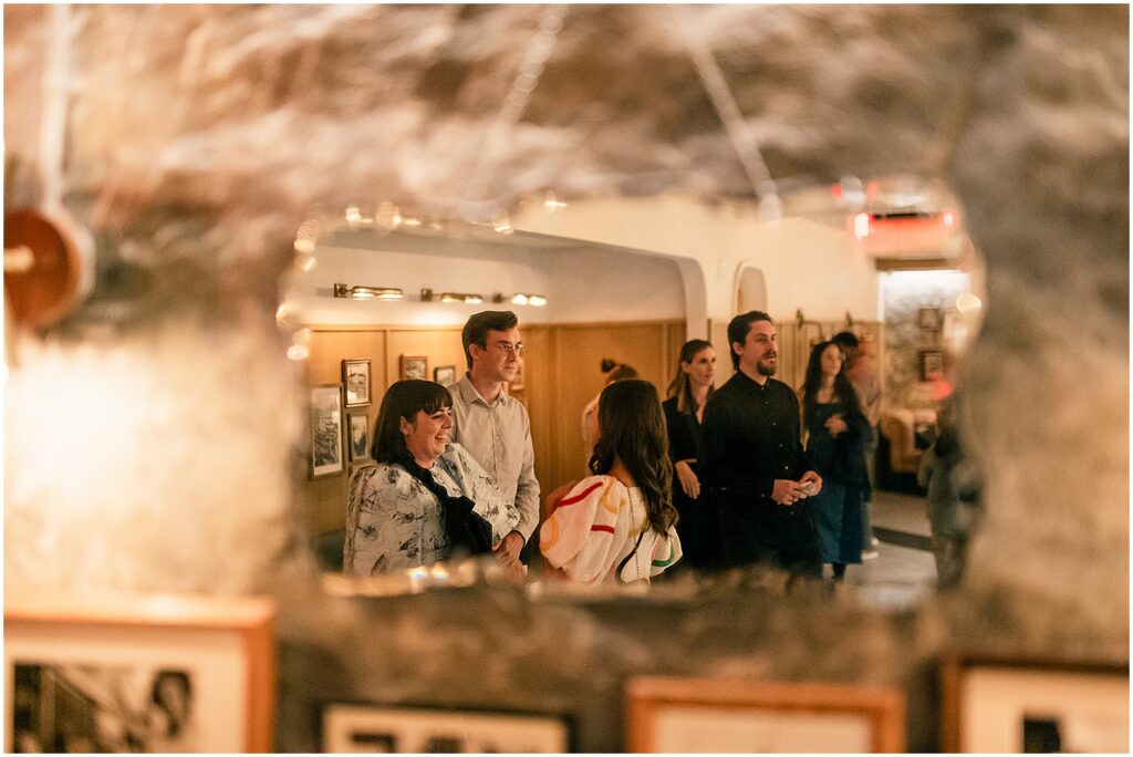 Wedding guests listen to a toast inside a Philadelphia restaurant.