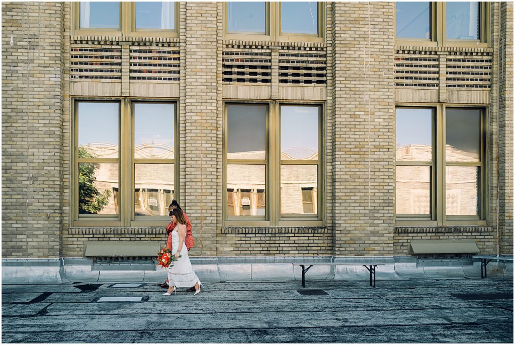 Two brides walk outside the BOK Building in Philadelphia.