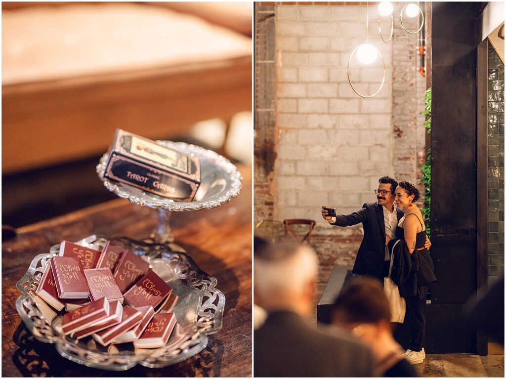 Tarot cards and matchbooks sit in silver trays on a wedding reception table.