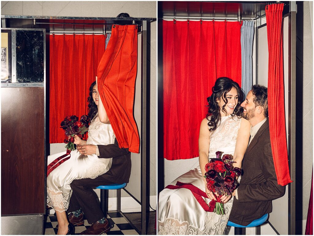 A bride sits on a groom's lap inside a photobooth.