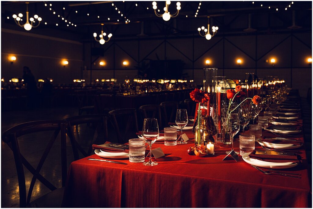 Red flowers and linens decorate wedding reception tables at Lilah Philadelphia.