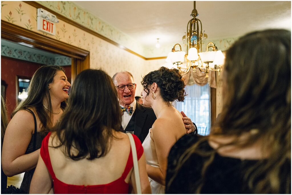 A bride speaks with a circle of family members.
