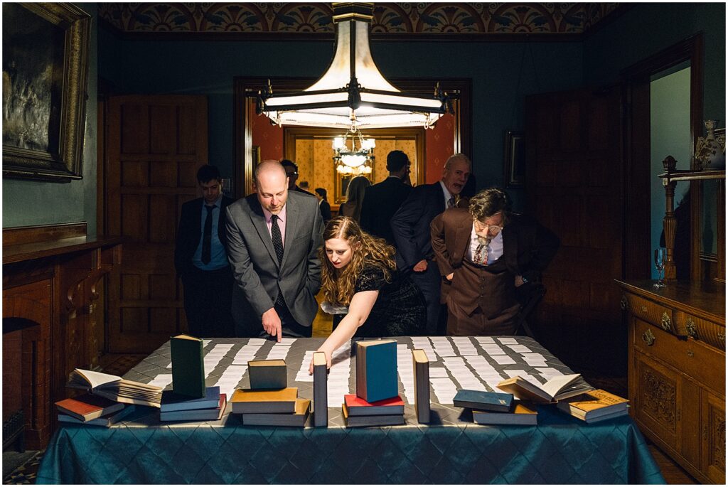 Wedding guests pick up place cards at a table.