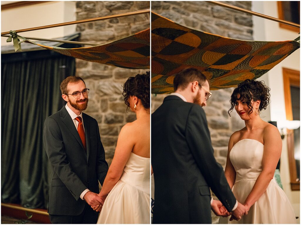 A bride and groom hold hands under a hand quilted chuppah.