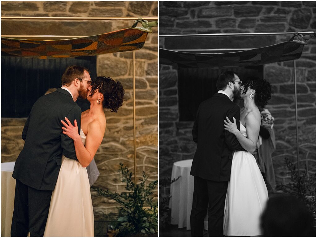 A bride and groom share their first kiss at their Philly wedding.