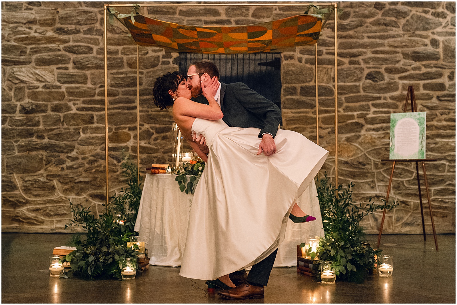 A groom dips a bride for a kiss at the end of their Knowlton Mansion wedding ceremony.