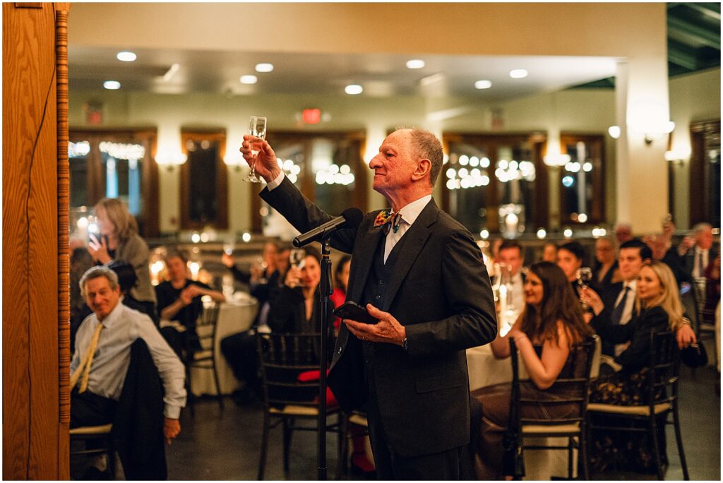 A family member raises his glass for a toast.