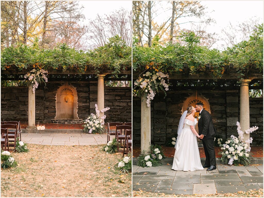 A bride and groom kiss under an arbor in Curtis Arboretum.