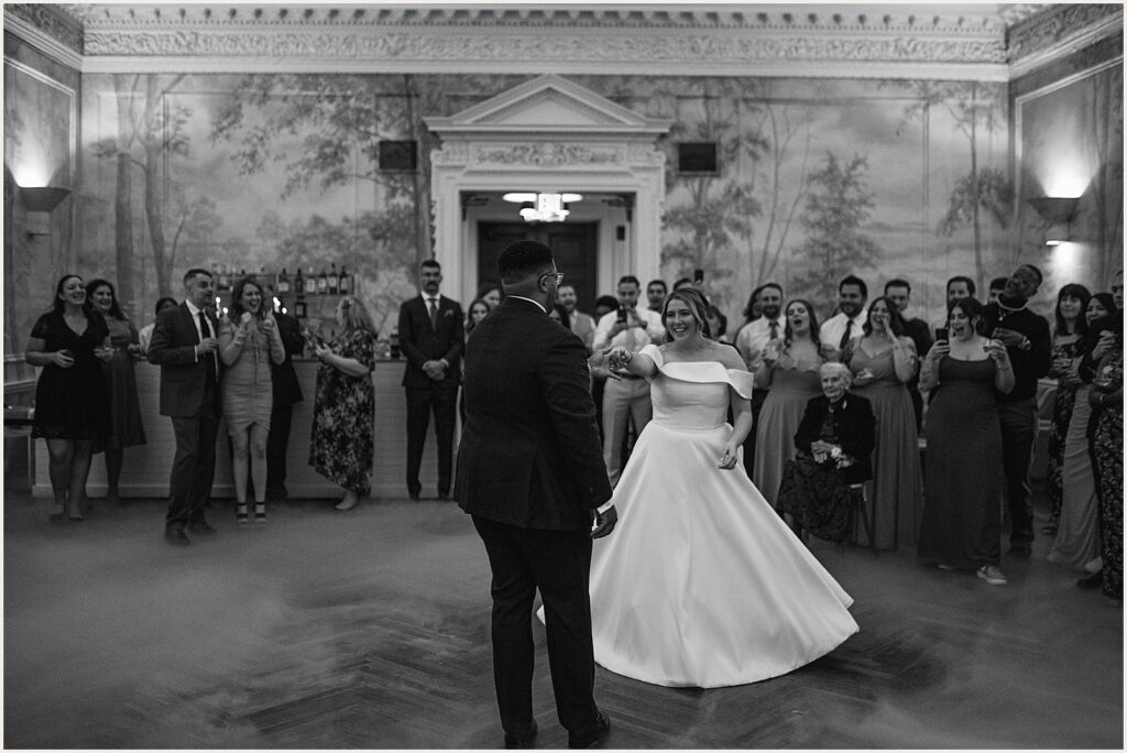 A groom twirls a bride on the dance floor.