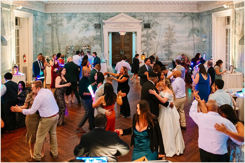 Wedding guests gather on the dance floor at a Curtis Arboretum wedding.